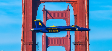 A U.S. Navy Blue Angels jet flying over San Francisco Bay during the Fleet Week air show
